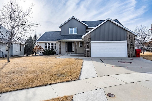 view of front facade featuring a front lawn, concrete driveway, brick siding, and an attached garage