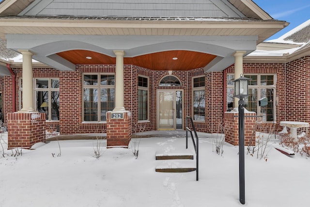 snow covered patio with covered porch