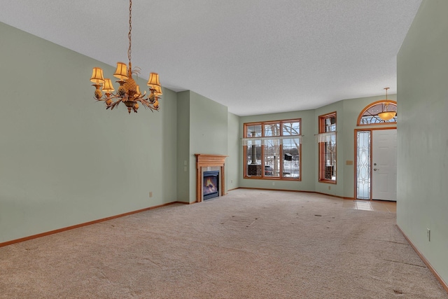 unfurnished living room featuring a lit fireplace, carpet, and baseboards