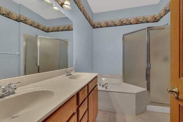 bathroom with a shower stall, a sink, a garden tub, and tile patterned floors