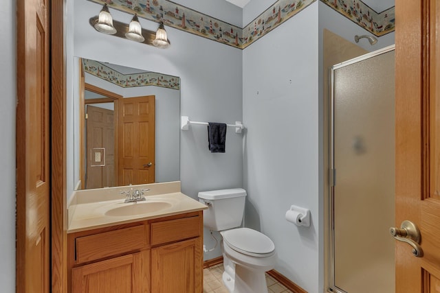 full bathroom featuring vanity, a shower stall, toilet, and baseboards