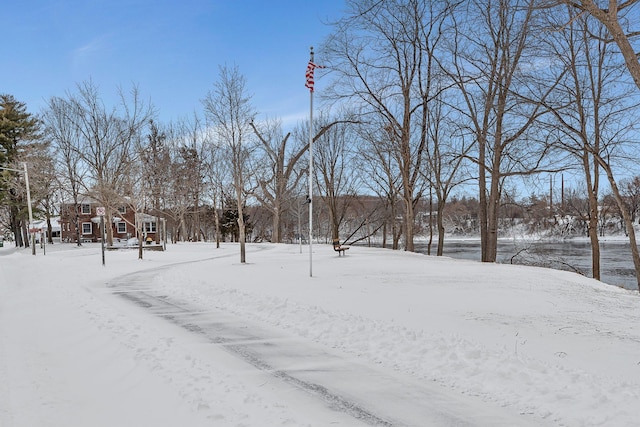 snowy yard with a garage