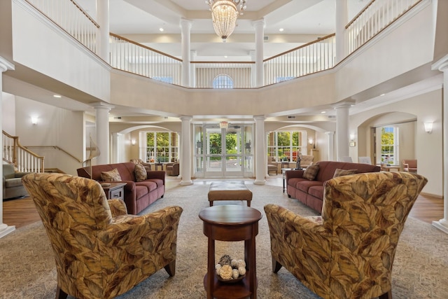 600 Greenhaven Dr Unit 209, Burnsville, MN 55306 - living area featuring ornate columns, a towering ceiling, recessed lighting, arched walkways, and stairway