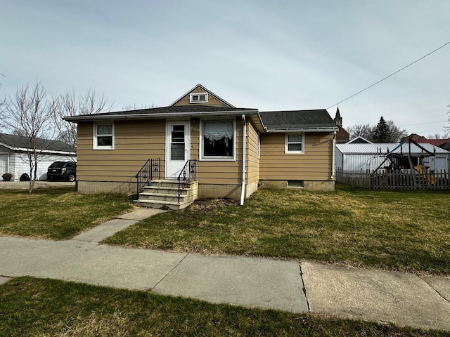 409 Main St SW, Preston, MN 55965 - bungalow-style house with fence and a front lawn