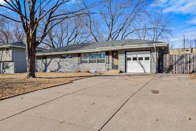 ranch-style home with roof with shingles, fence, driveway, and an attached garage