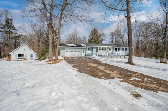 view of front of house with covered porch, driveway, and an attached garage