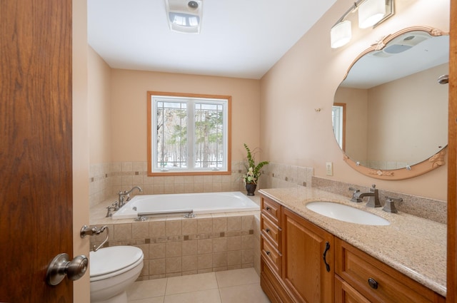 full bathroom with tile patterned floors, vanity, toilet, and a bath