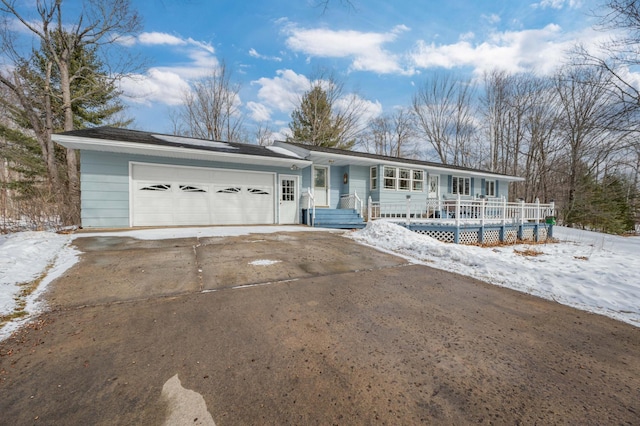 ranch-style home with an attached garage and concrete driveway