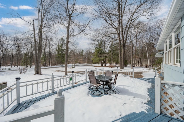 snow covered deck with outdoor dining area