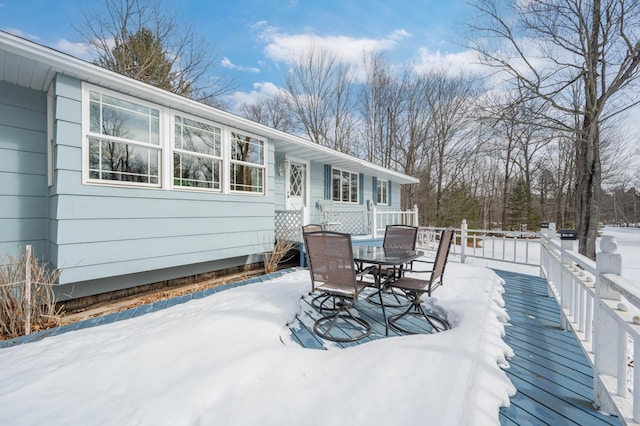 snow covered deck with outdoor dining area