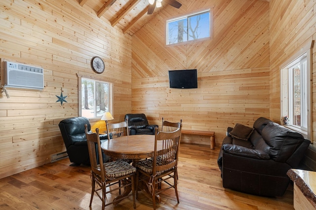 dining room with light wood-style flooring, high vaulted ceiling, beamed ceiling, and an AC wall unit