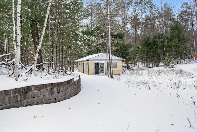 yard covered in snow featuring an outbuilding