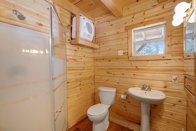 full bath with toilet, a stall shower, and wood finished floors