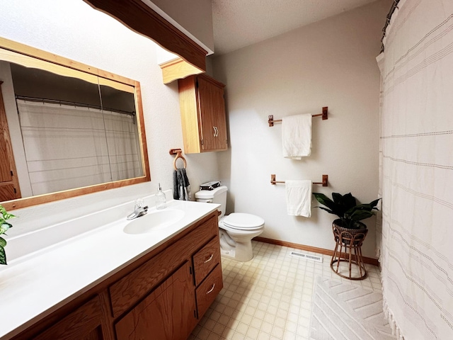 full bathroom with baseboards, visible vents, toilet, tile patterned floors, and vanity