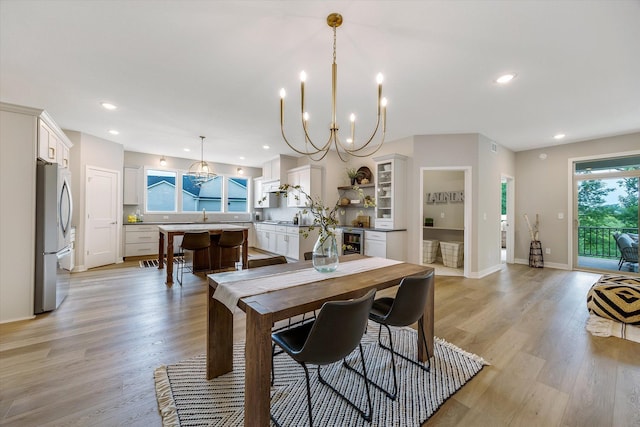 dining area featuring baseboards, wine cooler, light wood-type flooring, and recessed lighting