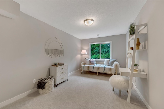 bedroom with a textured ceiling, baseboards, and carpet flooring