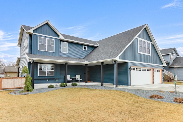 view of front of home featuring a porch, a shingled roof, fence, concrete driveway, and a front lawn