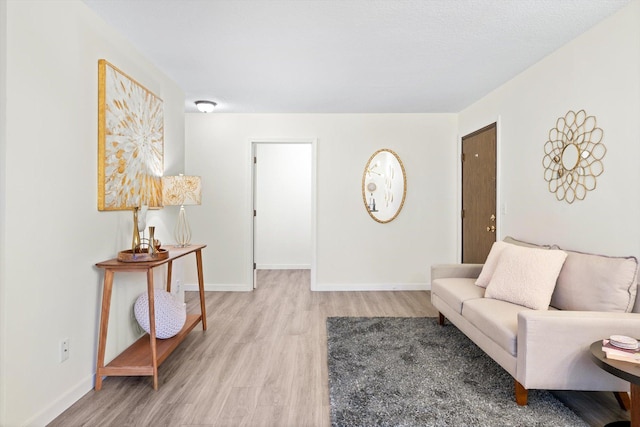living room featuring light wood-style floors and baseboards