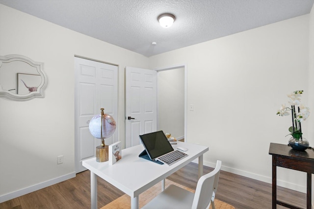 office space featuring baseboards, a textured ceiling, and wood finished floors