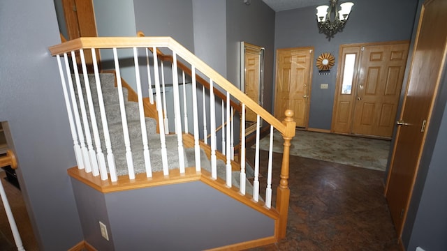 stairs with a notable chandelier