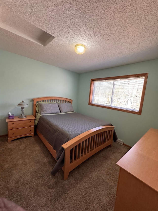 carpeted bedroom with a textured ceiling