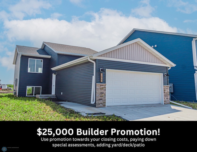 6756 66th Ave S, Horace, ND 58047 - view of front of home featuring an attached garage, concrete driveway, stone siding, and board and batten siding