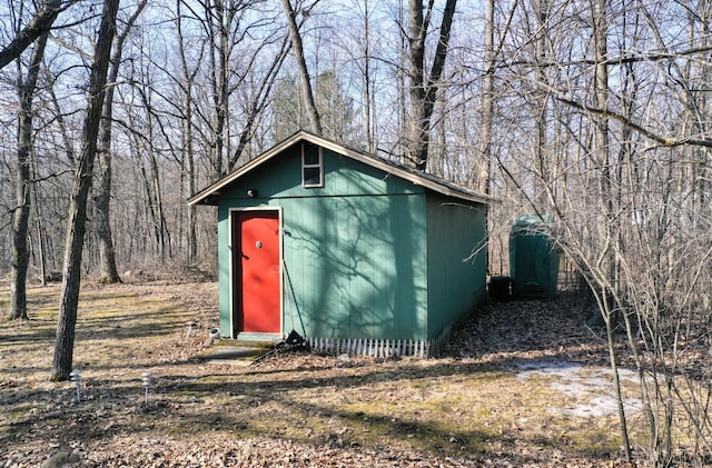 view of shed with a wooded view