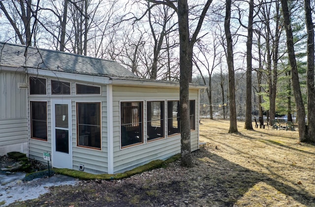 view of home's exterior featuring board and batten siding and a shingled roof