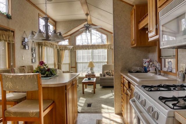 kitchen with white appliances, brown cabinetry, and light countertops