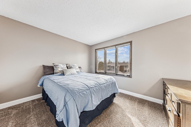 carpeted bedroom with baseboards and a textured ceiling