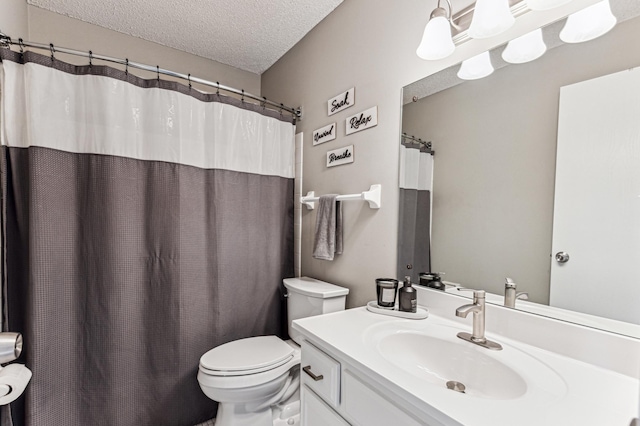 bathroom with vanity, a shower with shower curtain, toilet, and a textured ceiling