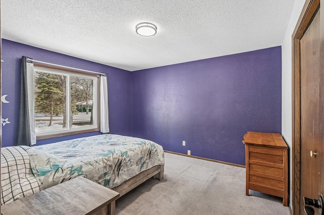 carpeted bedroom with baseboards, a textured ceiling, and a textured wall