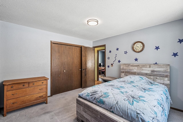 bedroom with a textured ceiling, a closet, and light colored carpet