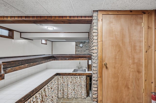 kitchen with a sink and tile counters