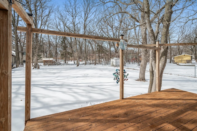 snowy yard featuring fence