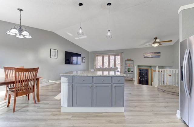 kitchen featuring gray cabinetry, light wood-style floors, open floor plan, vaulted ceiling, and stainless steel fridge with ice dispenser