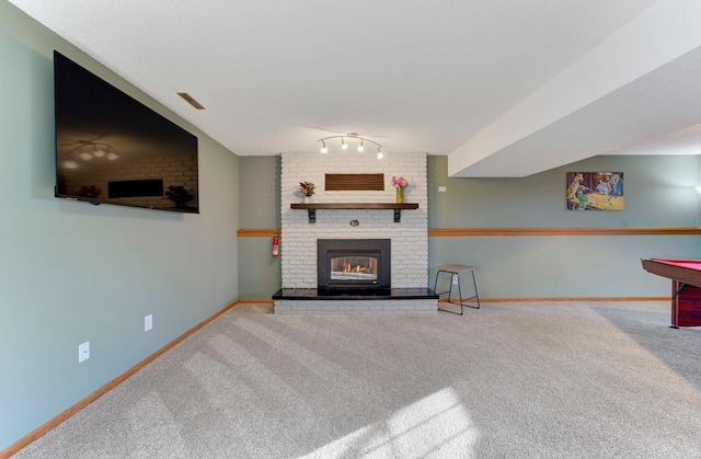 living room featuring carpet, a brick fireplace, visible vents, and baseboards