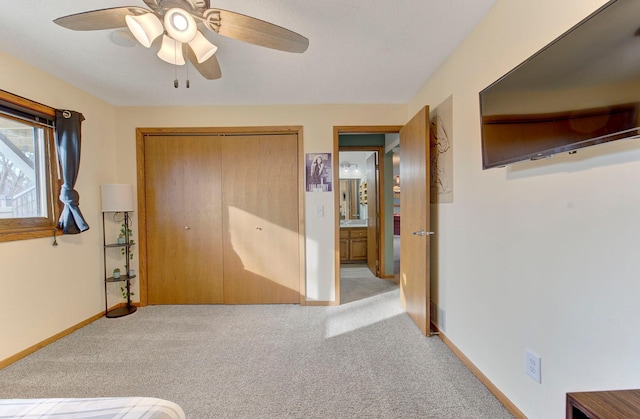 unfurnished bedroom featuring a ceiling fan, carpet, baseboards, and a closet