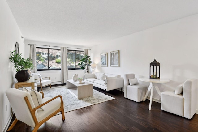 living area featuring dark wood-type flooring and baseboards