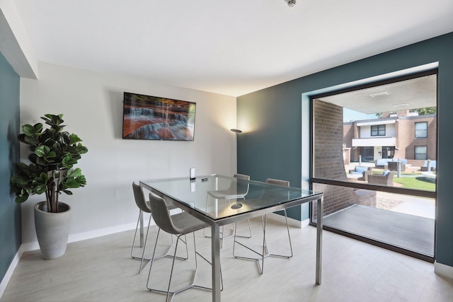 dining room featuring baseboards and wood finished floors