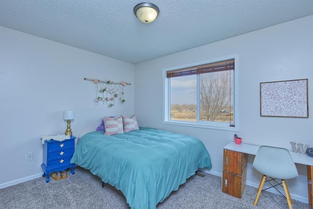 bedroom with carpet, a textured ceiling, and baseboards