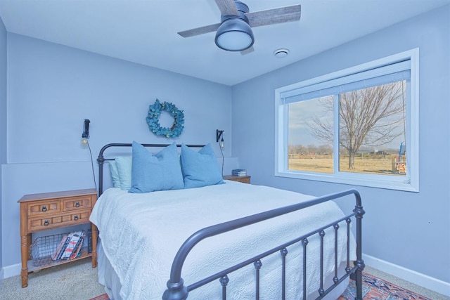 carpeted bedroom featuring ceiling fan and baseboards