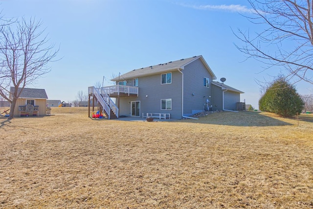 back of house with a patio area, stairway, a lawn, and a wooden deck