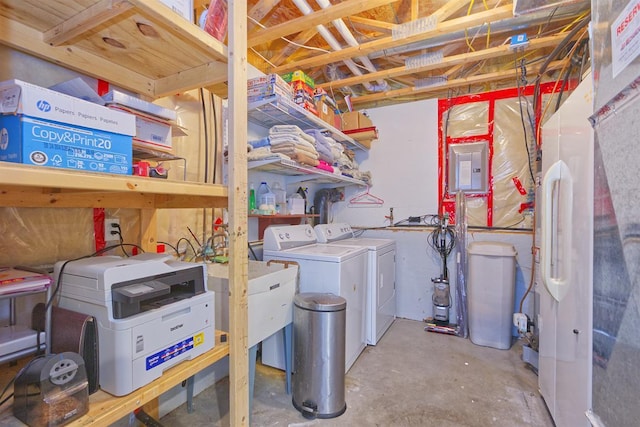 interior space with electric panel and washer and clothes dryer