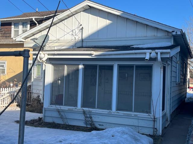 exterior space with board and batten siding and fence