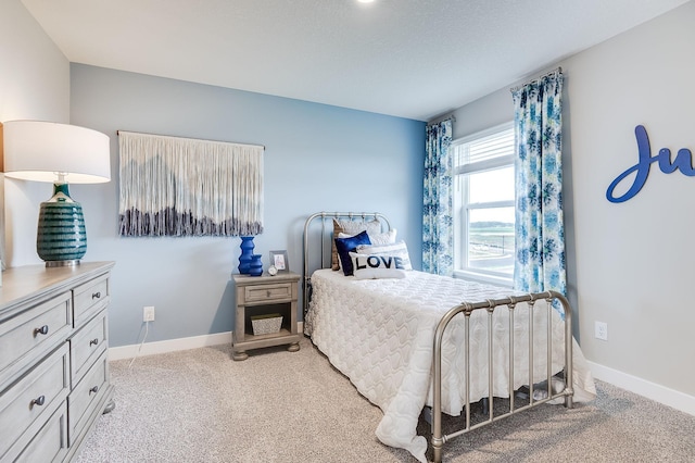 bedroom featuring light colored carpet and baseboards