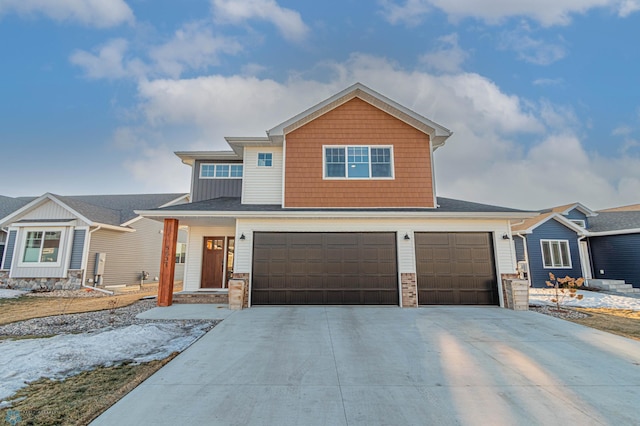 craftsman inspired home with a garage and driveway