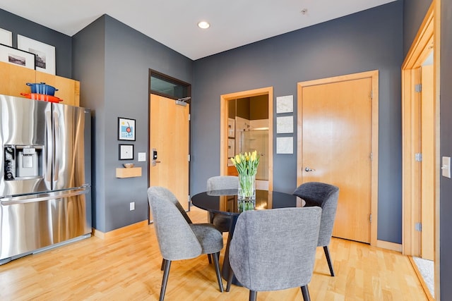 dining space with light wood-style flooring, recessed lighting, and baseboards