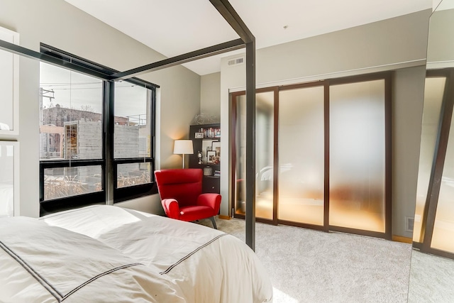 carpeted bedroom featuring visible vents