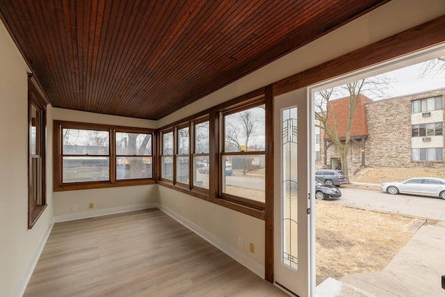 unfurnished sunroom with wooden ceiling